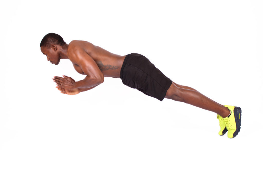 Athletic Male Doing Incline Push Ups on A Bench Outdoors Athletic Male Doing Incline Push Ups on A Bench Outdoors